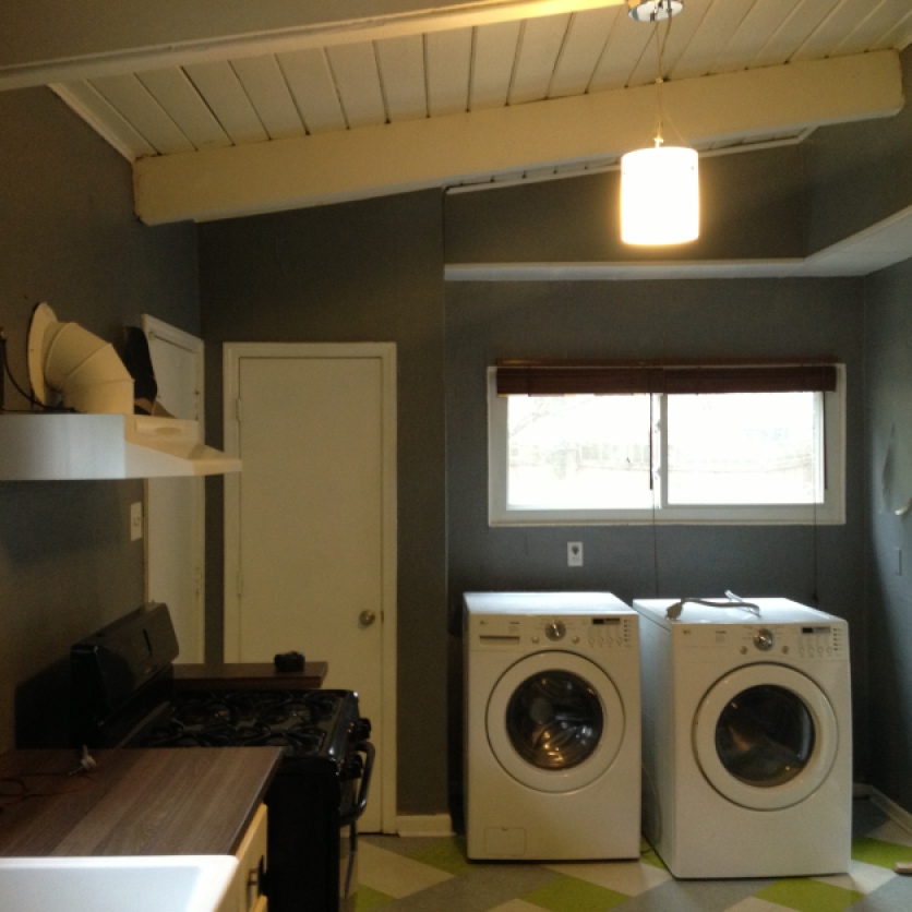 kitchen entry before with pantry and laundry. The washer and drier combo was left by the previous owners.
